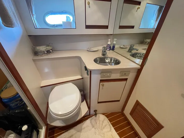 The Lucky Dreamers Yacht Photos Pics 2005 Novatec 48 Cockpit Motor Yacht bathroom with sink, toilet, and mirror.