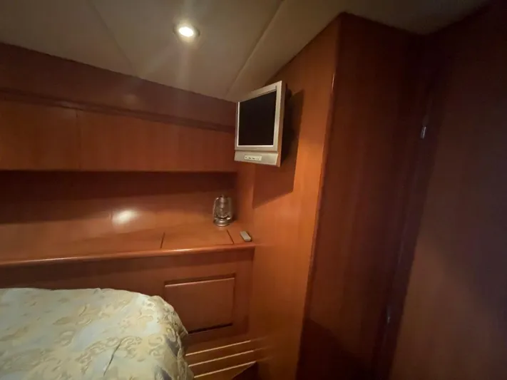 The Lucky Dreamers Yacht Photos Pics 2005 Novatec 48 Cockpit Motor Yacht interior with wood paneling and mounted TV.