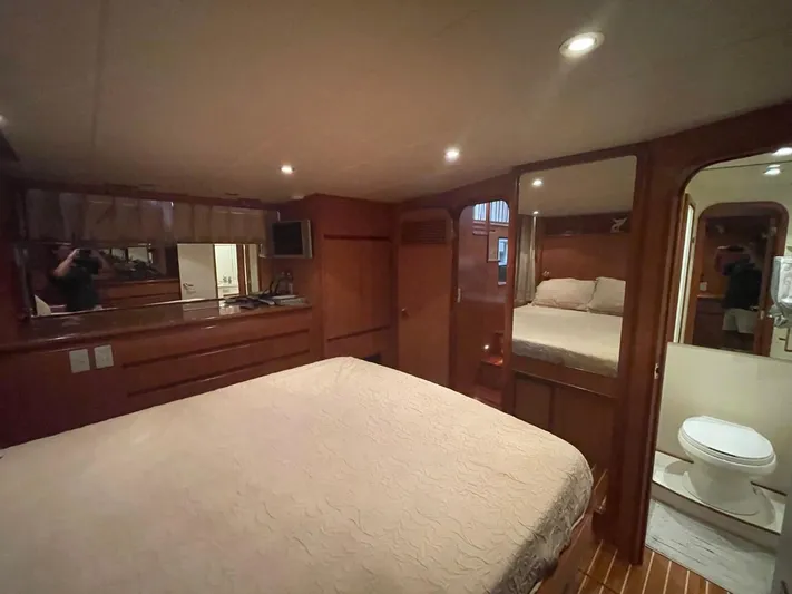 The Lucky Dreamers Yacht Photos Pics Luxurious bedroom interior of 2005 Novatec 48 Cockpit Motor Yacht with wood finishes.