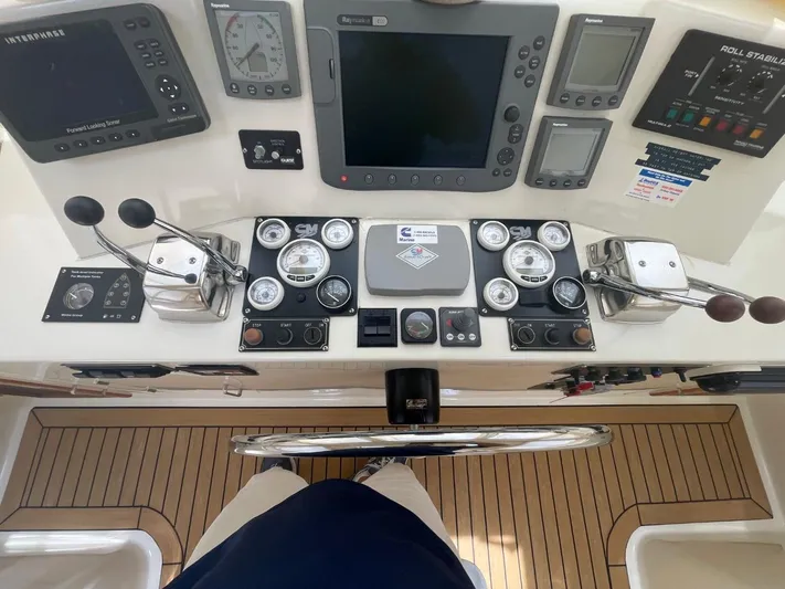 The Lucky Dreamers Yacht Photos Pics Cockpit controls of a 2005 Novatec 48 Motor Yacht, featuring navigation and engine instruments.