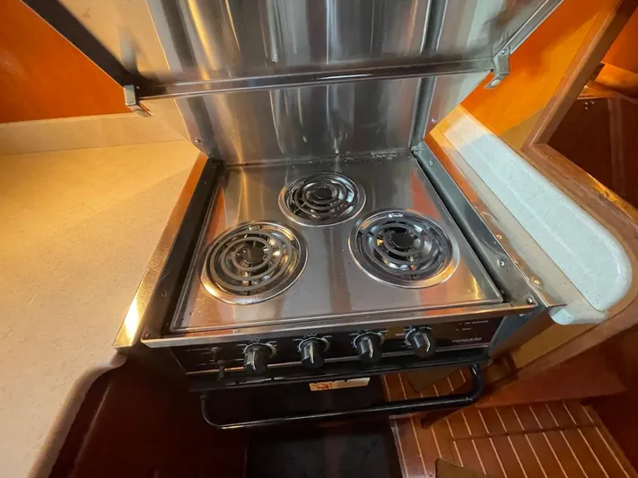 The Lucky Dreamers Yacht Photos Pics Stainless steel stove in 2005 Novatec 48 Cockpit Motor Yacht kitchen.