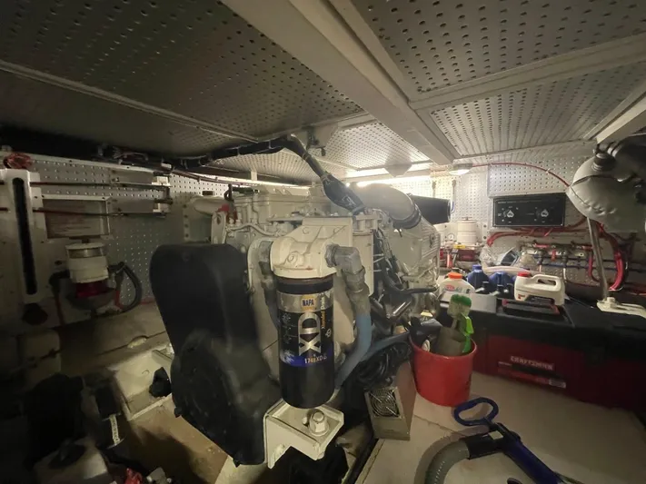 The Lucky Dreamers Yacht Photos Pics Engine room of 2005 Novatec 48 Cockpit Motor Yacht with visible equipment and tools.