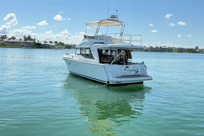  Yacht Photos Pics 2021 Beneteau Swift Trawler 35 on calm water, clear sky background.