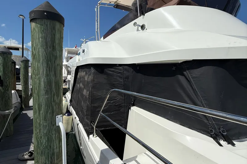  Yacht Photos Pics 2021 Beneteau Swift Trawler 35 docked, featuring sleek design and protective cover.