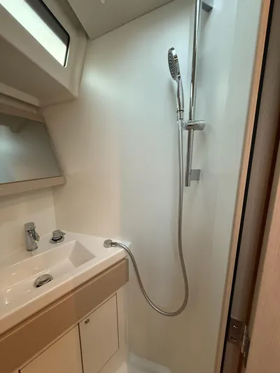 Archimedes Yacht Photos Pics Modern bathroom in 2022 Beneteau Oceanis 46.1 yacht with shower and sink.