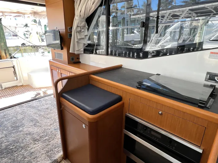  Yacht Photos Pics Interior of 2021 Beneteau Swift Trawler 35 with modern kitchen and seating area.