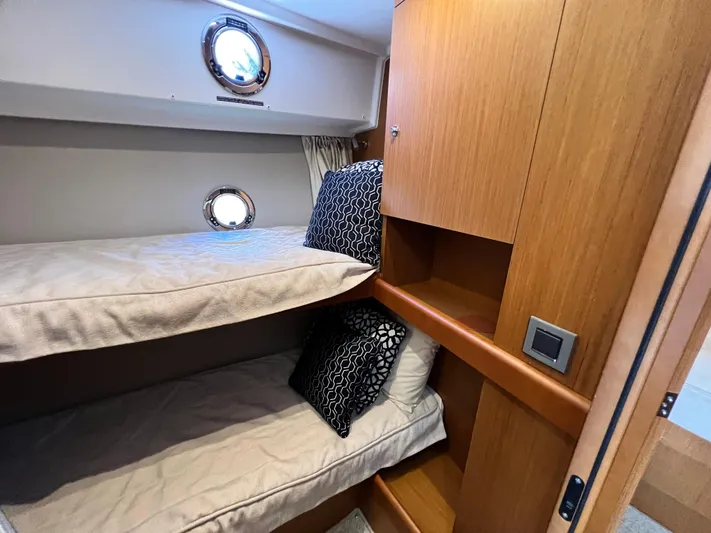  Yacht Photos Pics 2021 Beneteau Swift Trawler 35 cabin with bunk beds and wooden cabinetry.