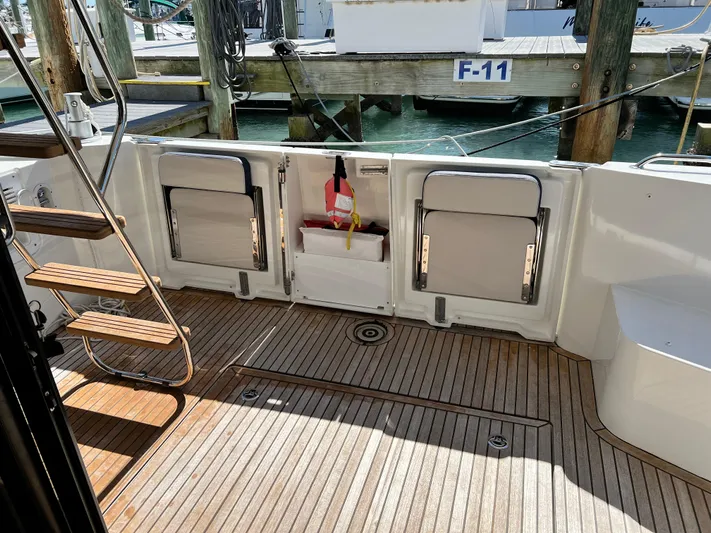  Yacht Photos Pics 2021 Beneteau Swift Trawler 35 aft deck with wooden flooring and dock access.