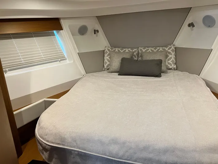  Yacht Photos Pics 2021 Beneteau Swift Trawler 35 bedroom with modern decor and comfortable bedding.