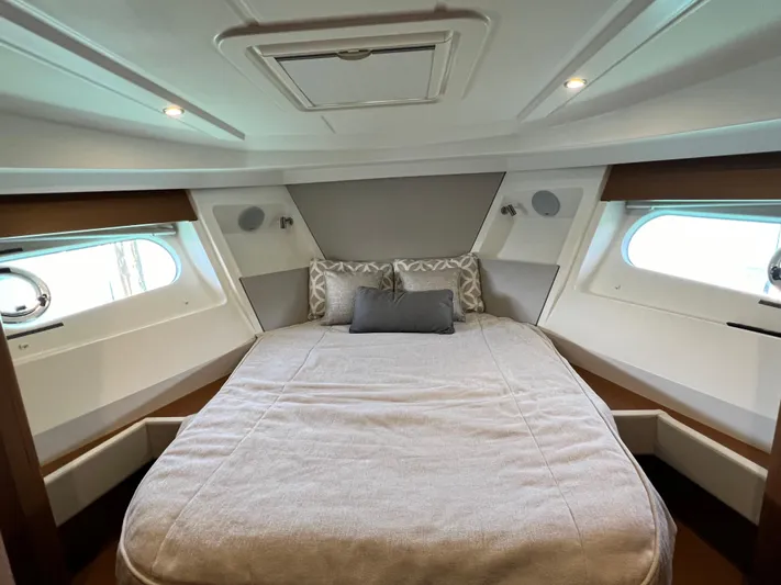  Yacht Photos Pics 2021 Beneteau Swift Trawler 35 master cabin with double bed and porthole windows.