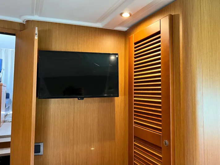  Yacht Photos Pics Flat-screen TV mounted on wooden wall inside 2021 Beneteau Swift Trawler 35.