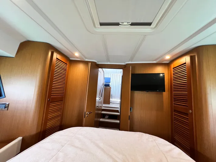  Yacht Photos Pics Interior cabin of 2021 Beneteau Swift Trawler 35 with wood paneling and TV.