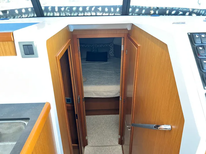  Yacht Photos Pics Interior cabin view of 2021 Beneteau Swift Trawler 35, featuring a cozy bed.