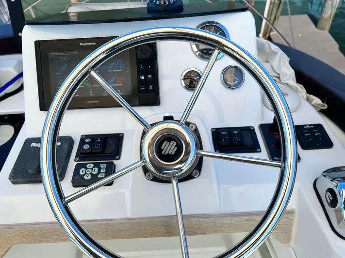  Yacht Photos Pics Steering wheel and control panel of a 2021 Beneteau Swift Trawler 35.