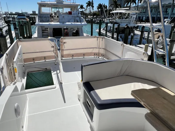  Yacht Photos Pics 2021 Beneteau Swift Trawler 35, spacious deck with seating, docked at marina.