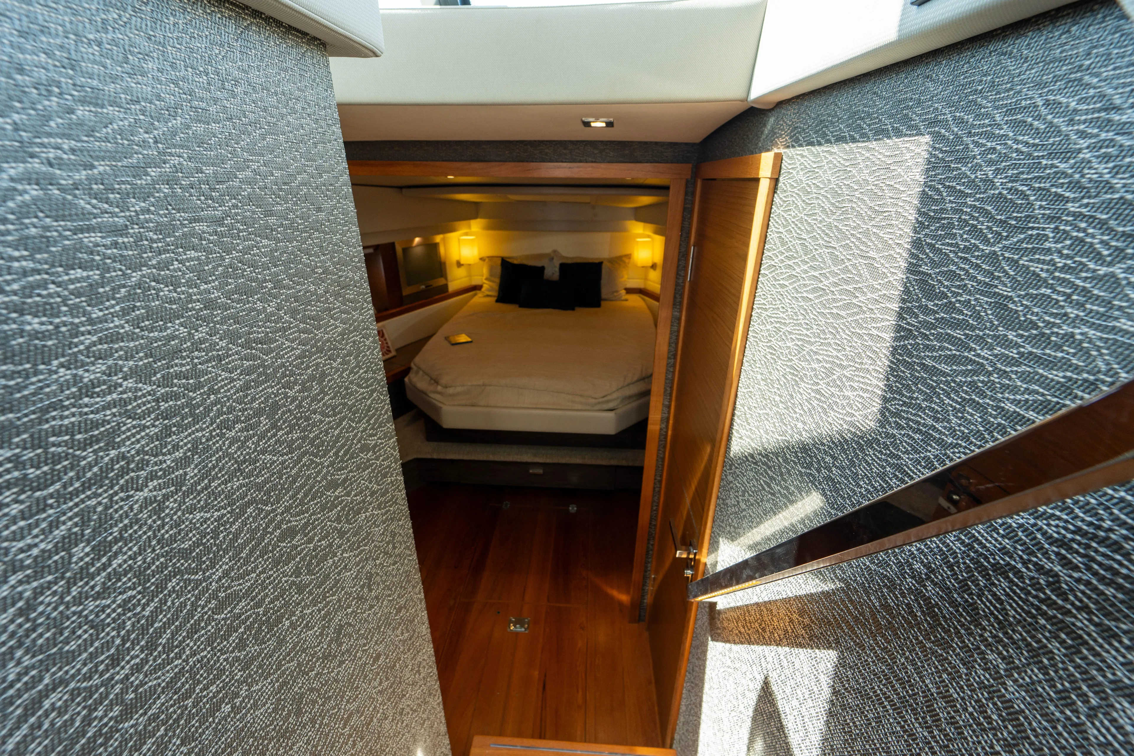  Yacht Photos Pics Luxurious cabin interior of 2019 Tiara Yachts F44 Flybridge with cozy bed and ambient lighting.