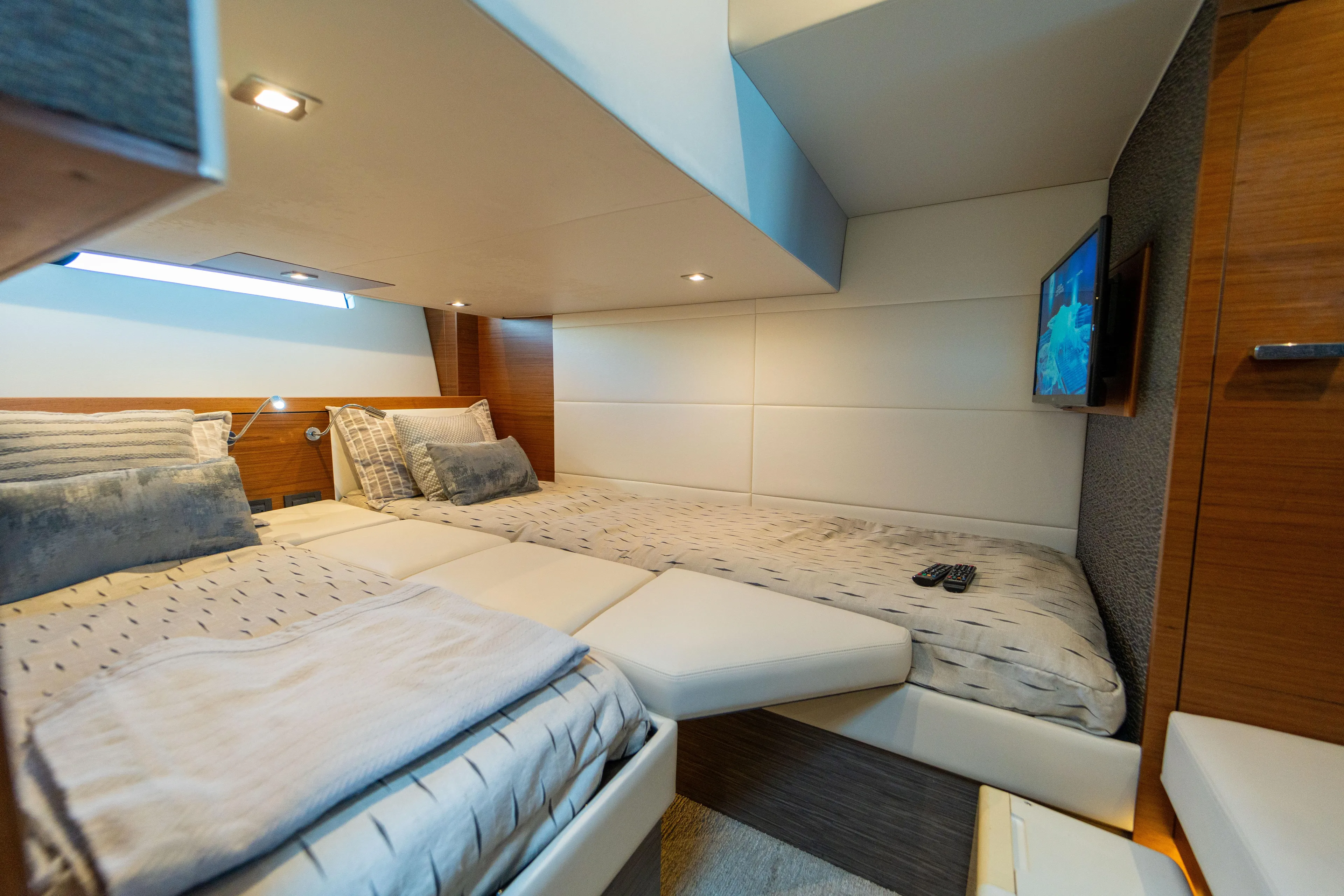  Yacht Photos Pics Luxurious cabin interior of 2019 Tiara Yachts F44 Flybridge with modern bedding and TV.