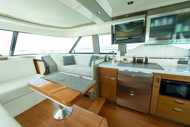  Yacht Photos Pics Luxurious interior of 2019 Tiara Yachts F44 Flybridge with modern kitchen and seating area.