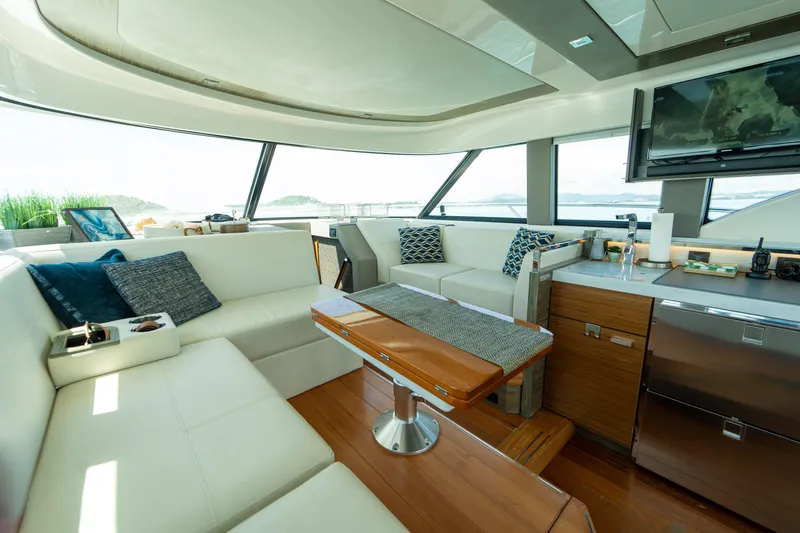  Yacht Photos Pics Luxurious interior of 2019 Tiara Yachts F44 Flybridge with modern seating and panoramic windows.
