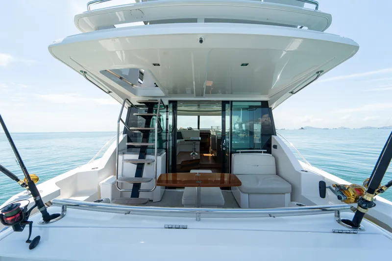  Yacht Photos Pics 2019 Tiara Yachts F44 Flybridge, rear view, open sea, fishing rods, luxurious seating.