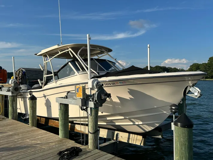  Yacht Photos Pics 2023 Grady-White Freedom 275 boat docked on a sunny day.