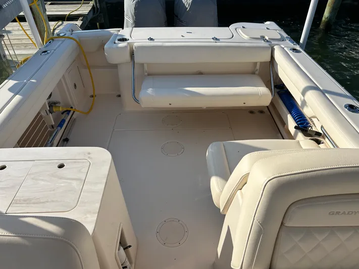  Yacht Photos Pics 2023 Grady-White Freedom 275 boat interior with beige seating and deck, docked at marina.