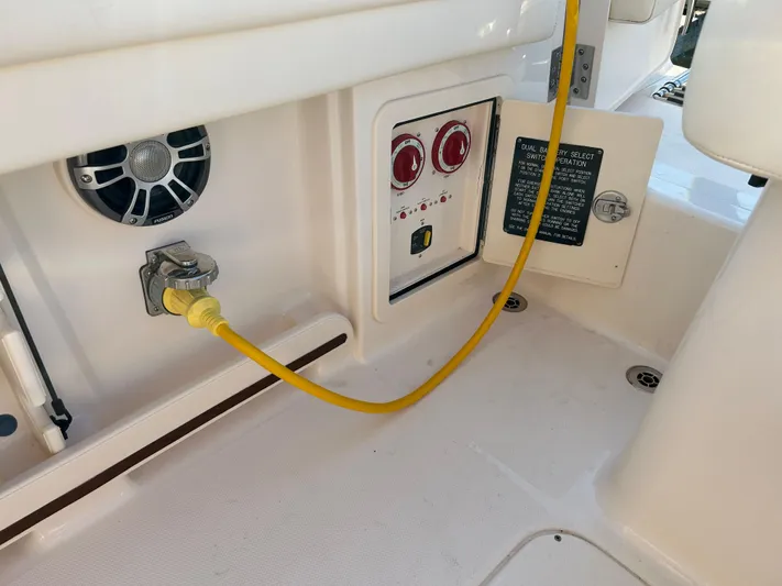  Yacht Photos Pics 2023 Grady-White Freedom 275 boat interior with control panel and yellow power cable.