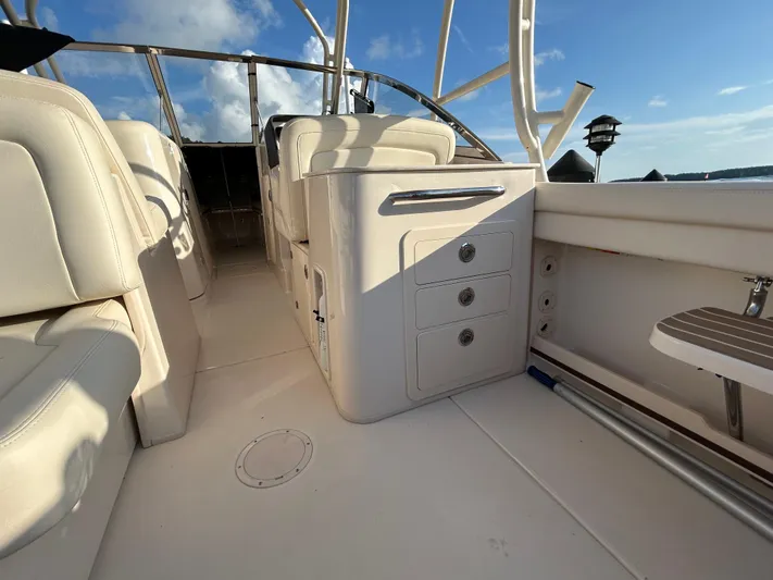  Yacht Photos Pics 2023 Grady-White Freedom 275 boat interior with seating and storage compartments.