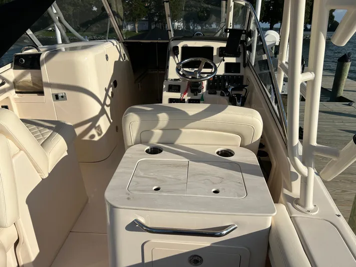  Yacht Photos Pics 2023 Grady-White Freedom 275 boat interior with helm and seating area.