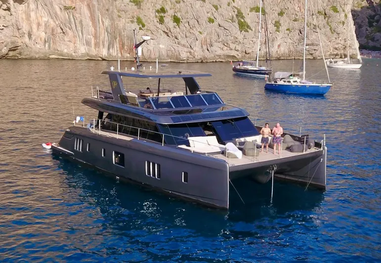  Yacht Photos Pics 2024 Sunreef 60 Eco yacht anchored in scenic coastal waters.