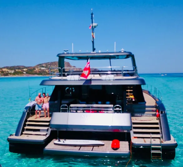  Yacht Photos Pics 2024 Sunreef 60 Eco yacht anchored in clear turquoise waters.