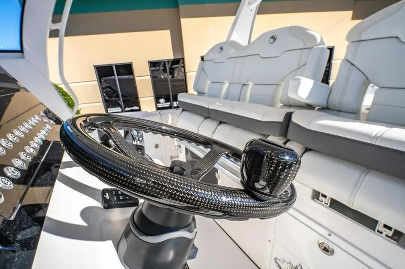  Yacht Photos Pics 2025 Edgewater 370CC boat interior with sleek steering wheel and luxurious seating.