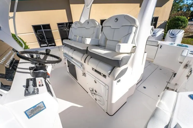  Yacht Photos Pics 2025 Edgewater 370CC boat interior with dual white captain seats and steering console.