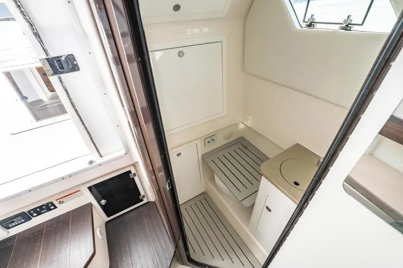  Yacht Photos Pics 2025 Edgewater 370CC boat interior with compact bathroom and modern amenities.