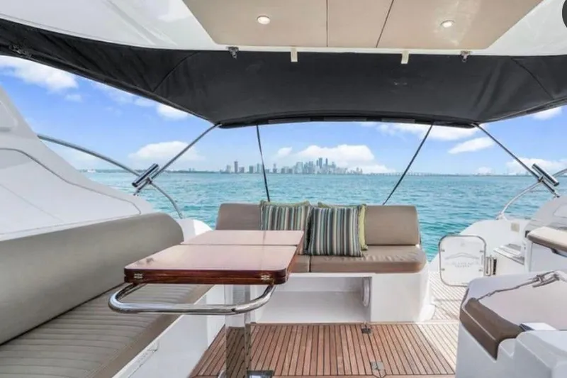  Yacht Photos Pics 2009 Four Winns V458 yacht interior with city skyline view, featuring seating and table.