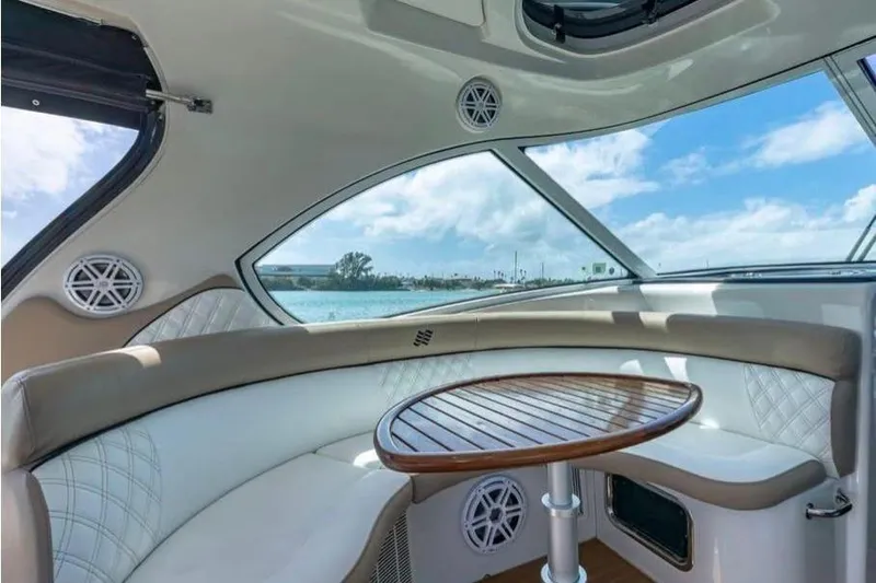  Yacht Photos Pics Interior of 2009 Four Winns V458 yacht with elegant seating and wooden table.