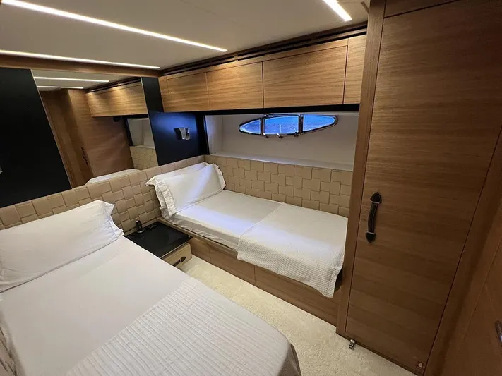 Yacht Photos Pics Luxurious cabin interior of 2012 Pershing 92 yacht with twin beds and wooden finish.