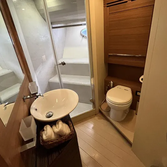  Yacht Photos Pics Luxurious bathroom on a 2012 Pershing 92 yacht with modern fixtures and wooden accents.