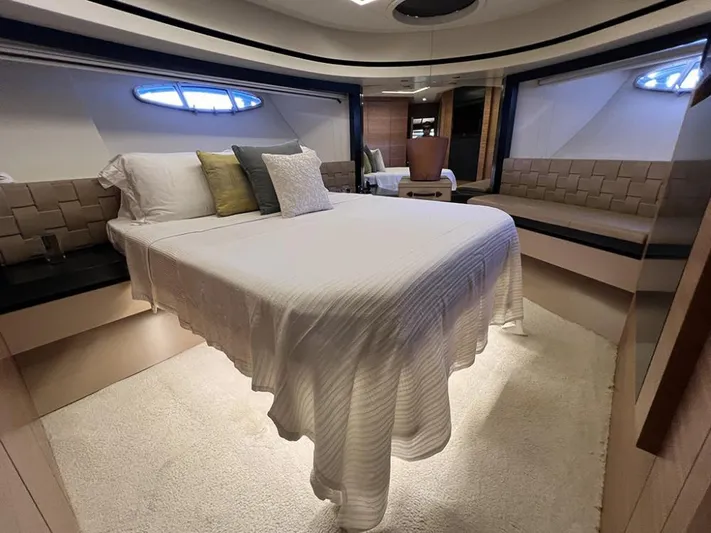  Yacht Photos Pics Luxurious bedroom interior of a 2012 Pershing 92 yacht with elegant bedding and seating.