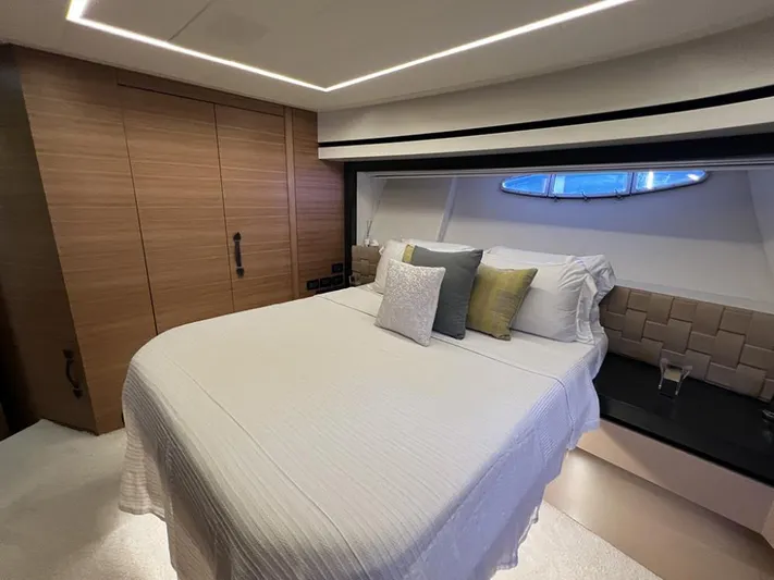  Yacht Photos Pics Luxurious bedroom interior on a 2012 Pershing 92 yacht, featuring modern design and cozy bedding.