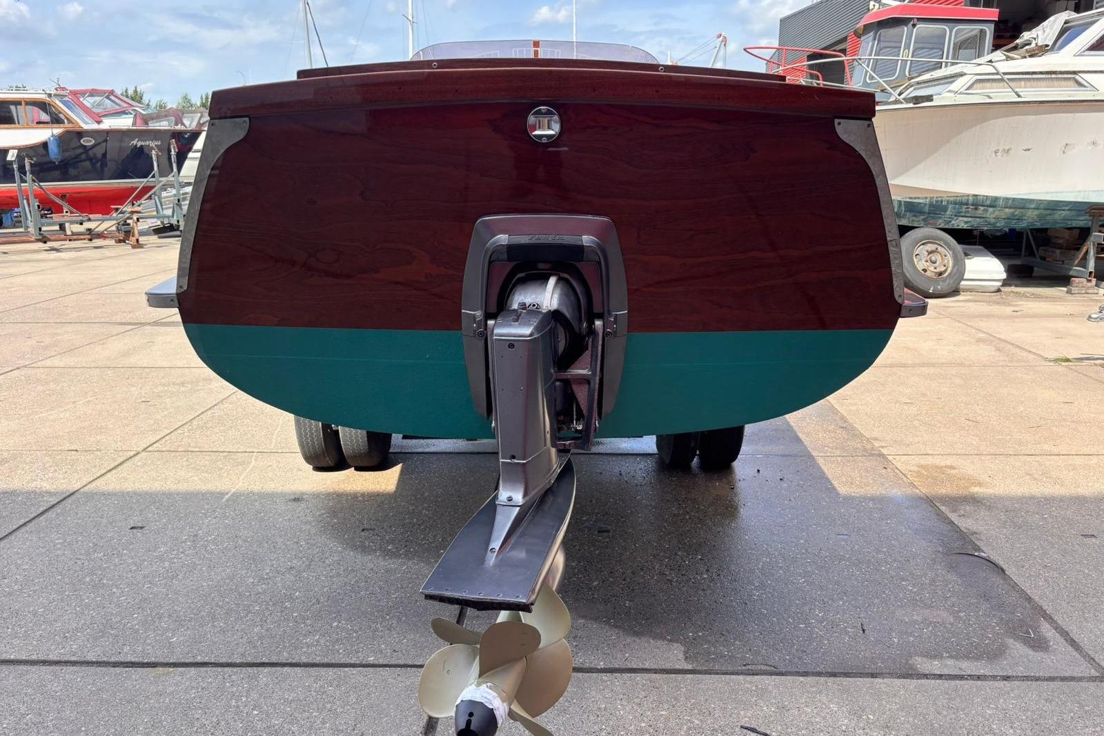 1953 Barca Di Legno Italiana 30 boat stern view with propeller, docked outdoors.