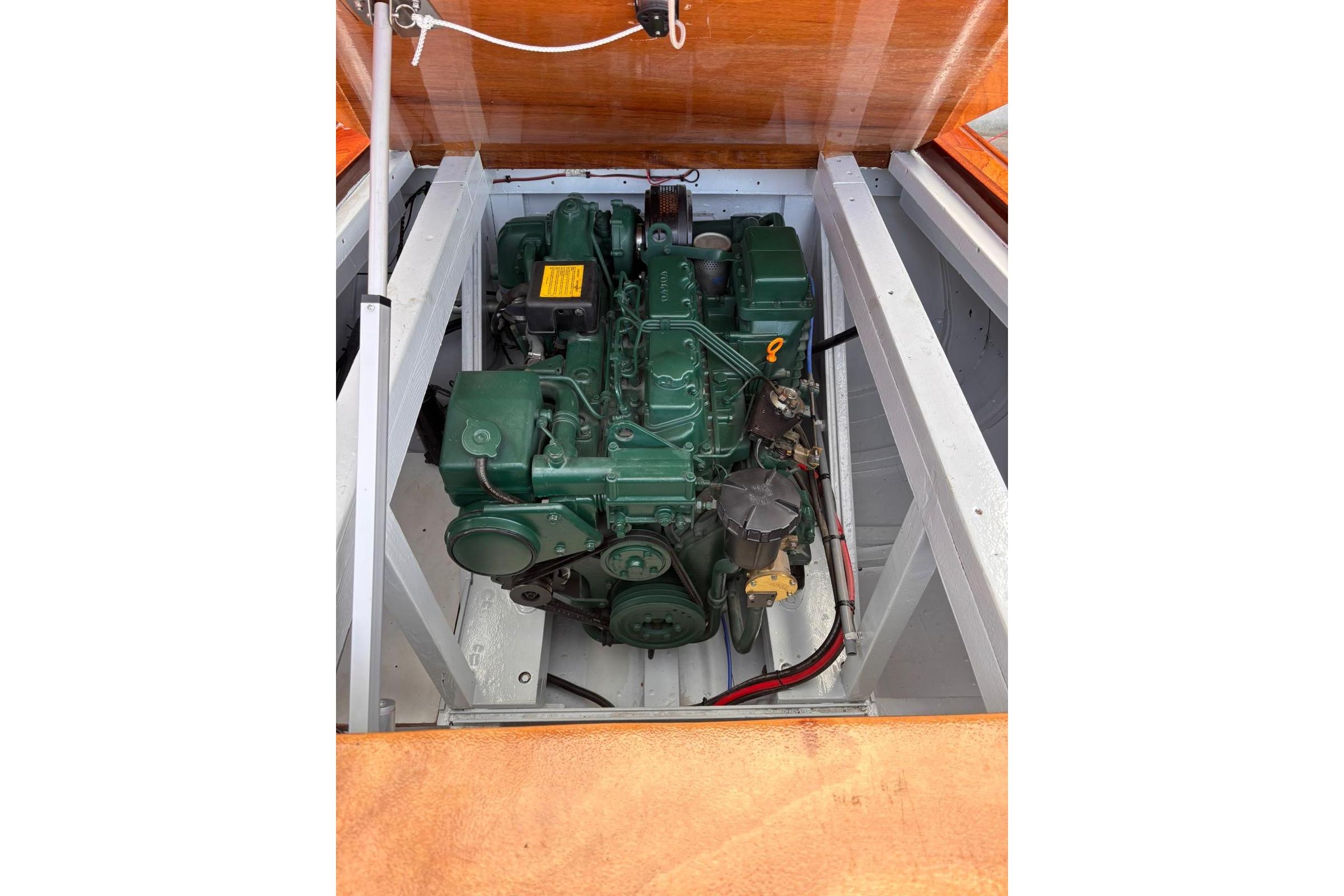 Engine of 1953 Barca Di Legno Italiana 30 boat, green and well-maintained.