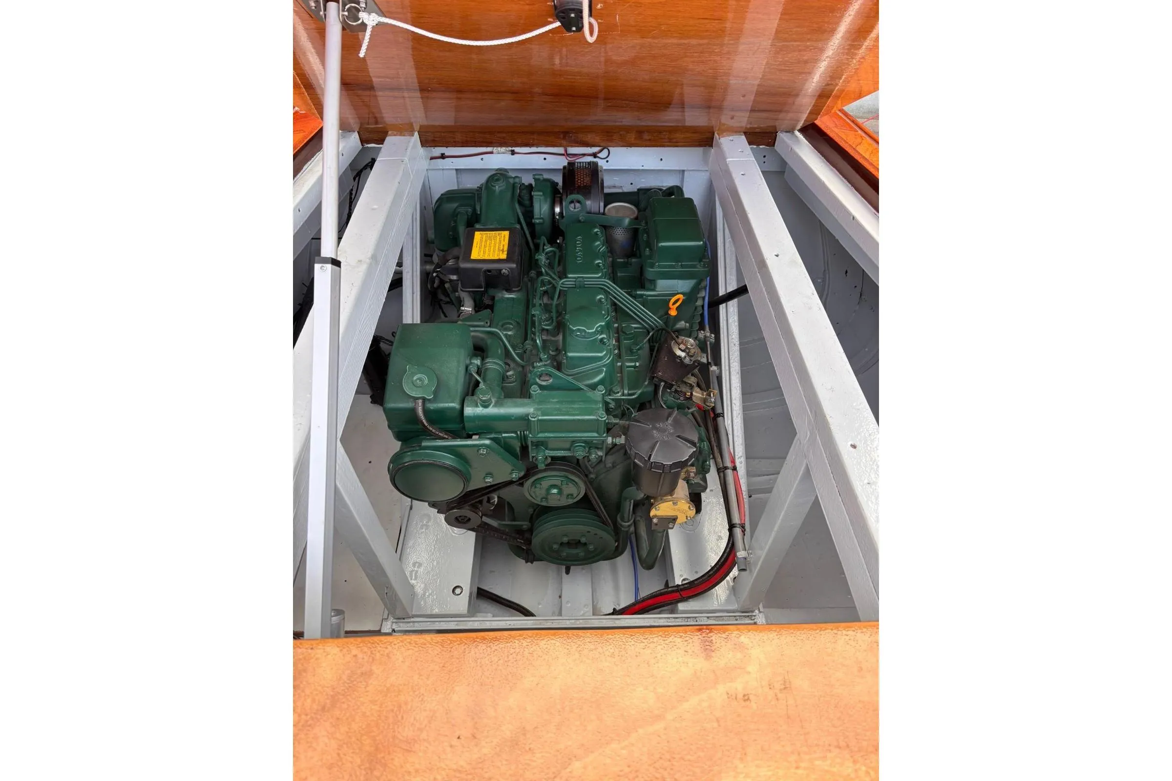 Engine of 1953 Barca Di Legno Italiana 30 boat, green and well-maintained.