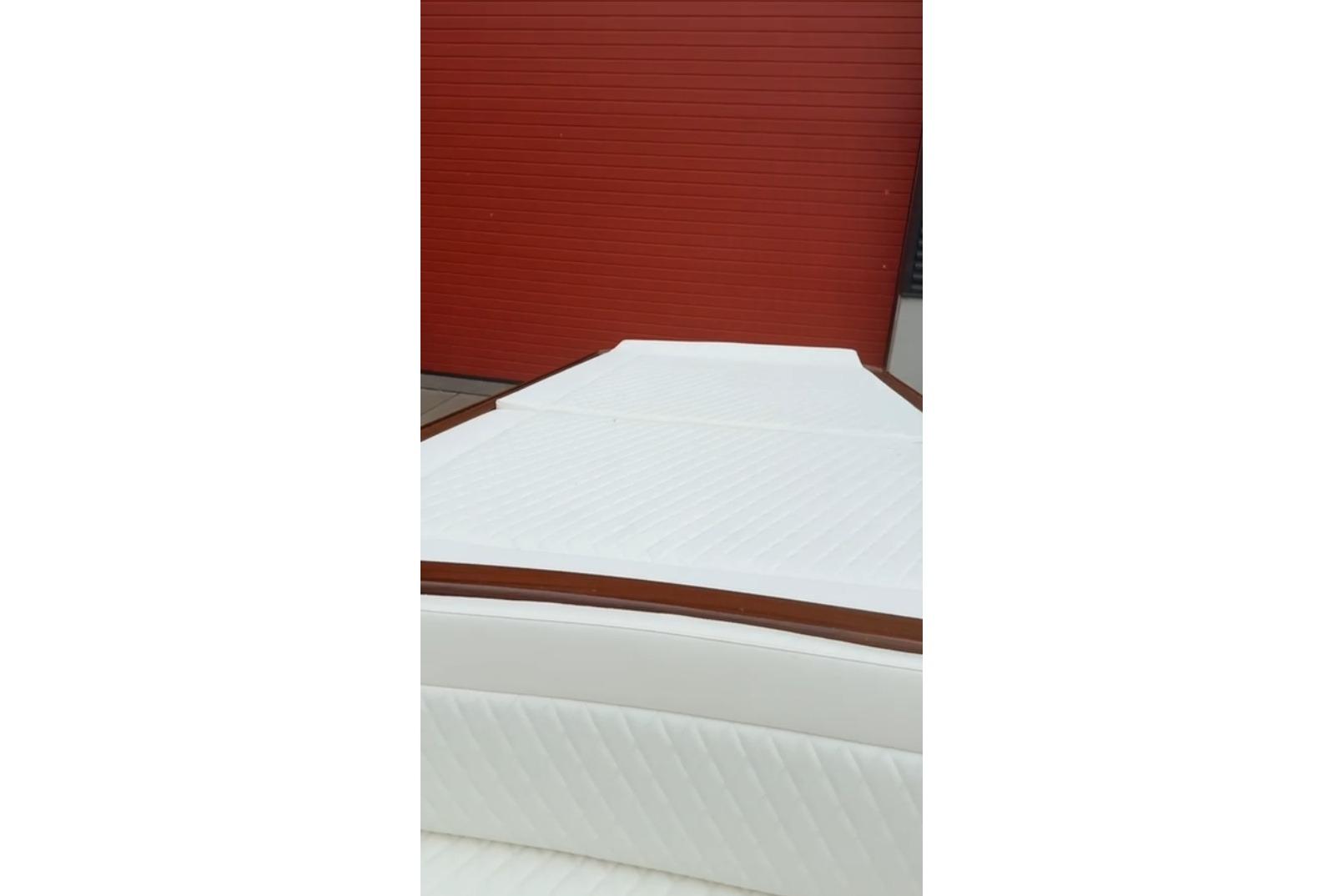 1953 Barca Di Legno Italiana 30 boat with white upholstery and red background.