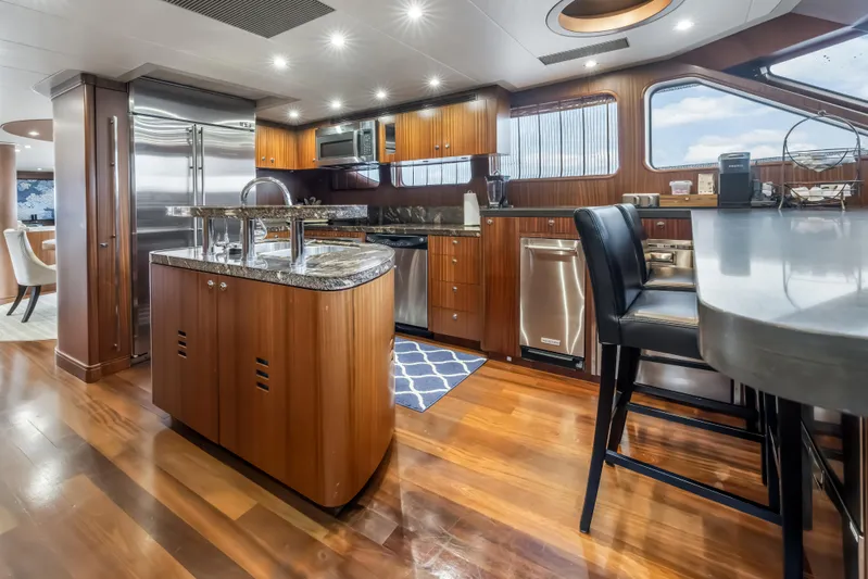 Jus Chill'n Yacht Photos Pics Luxurious kitchen interior of 2012 Cheoy Lee 84 Bravo yacht with modern appliances.