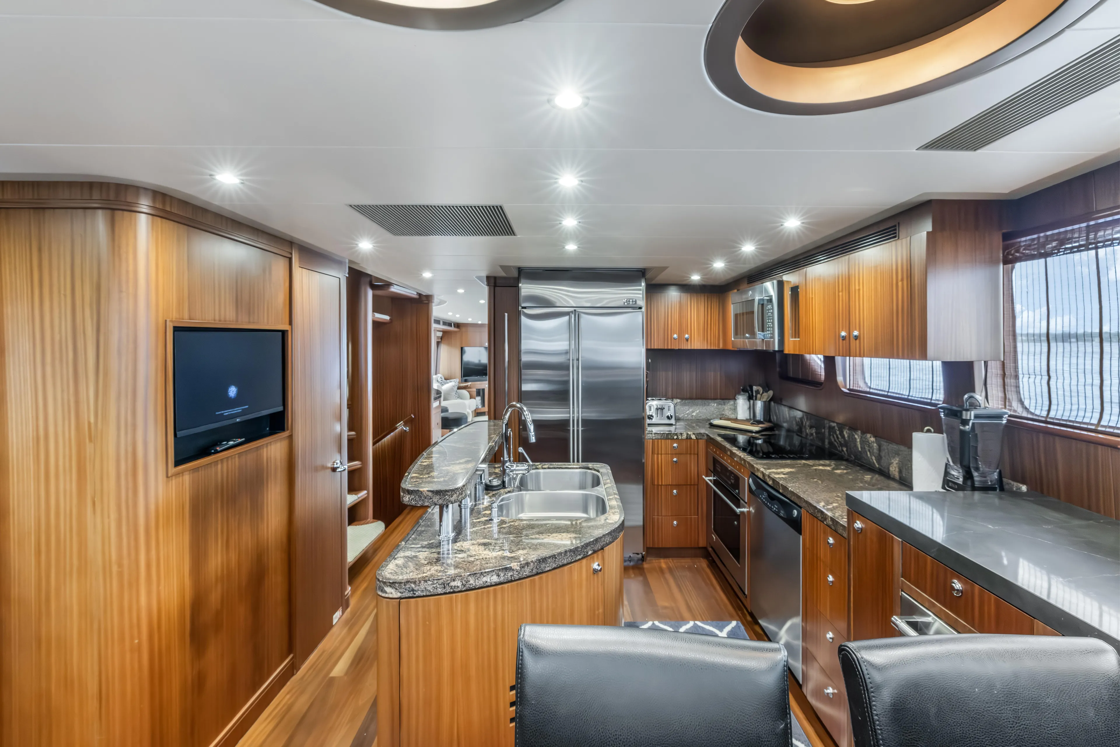 Jus Chill'n Yacht Photos Pics Luxurious 2012 Cheoy Lee 84 Bravo yacht kitchen with wood cabinetry and modern appliances.