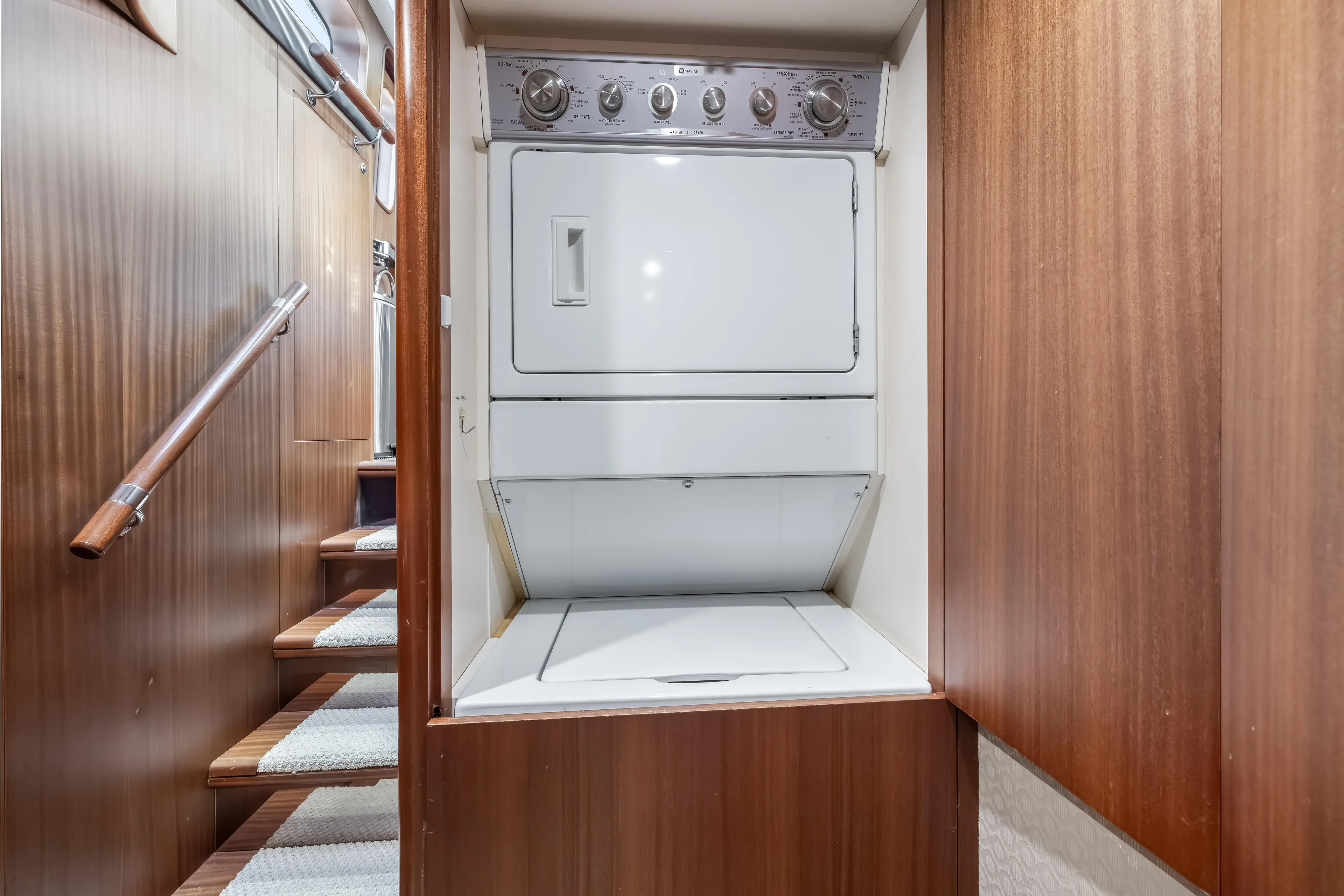 Jus Chill'n Yacht Photos Pics Laundry area with stacked washer and dryer on 2012 Cheoy Lee 84 Bravo yacht.