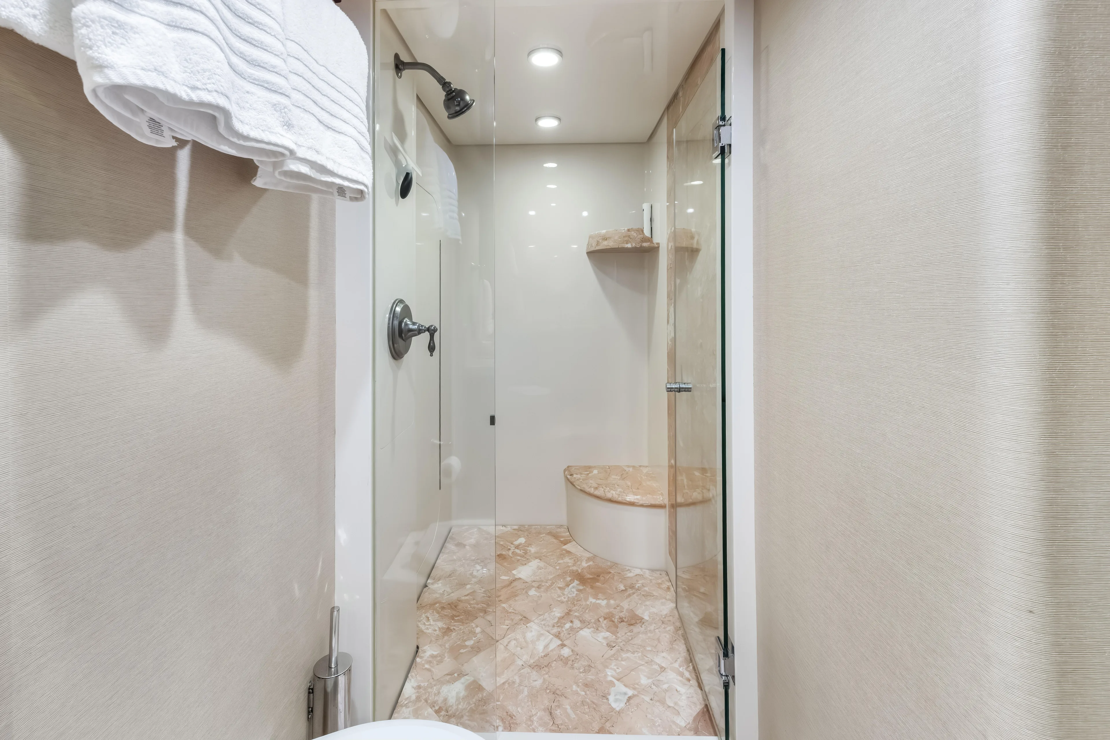 Jus Chill'n Yacht Photos Pics Luxurious shower in 2012 Cheoy Lee 84 Bravo yacht, featuring marble accents and glass door.