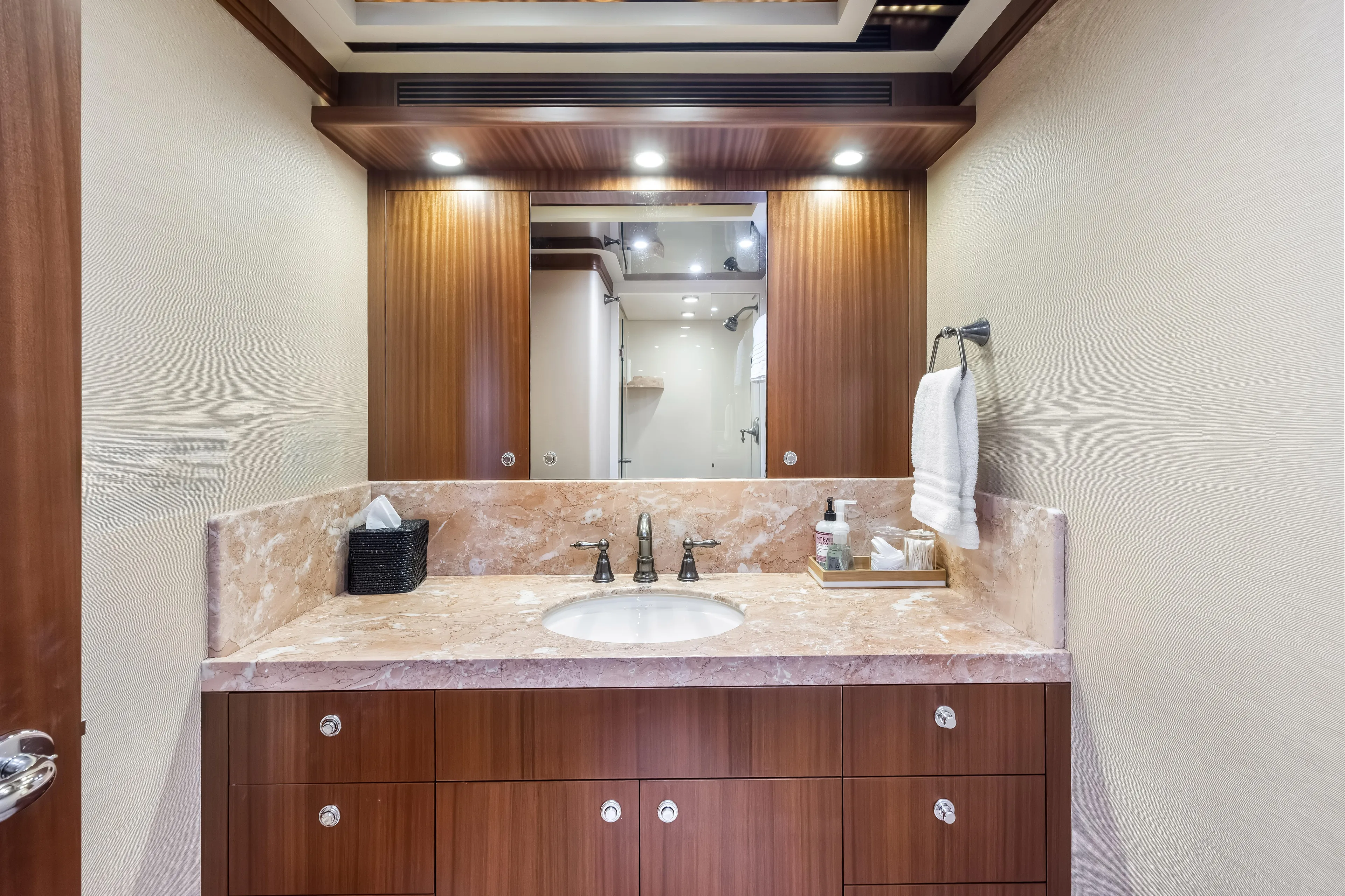 Jus Chill'n Yacht Photos Pics Luxurious bathroom on 2012 Cheoy Lee 84 Bravo yacht with marble countertop and wooden cabinetry.