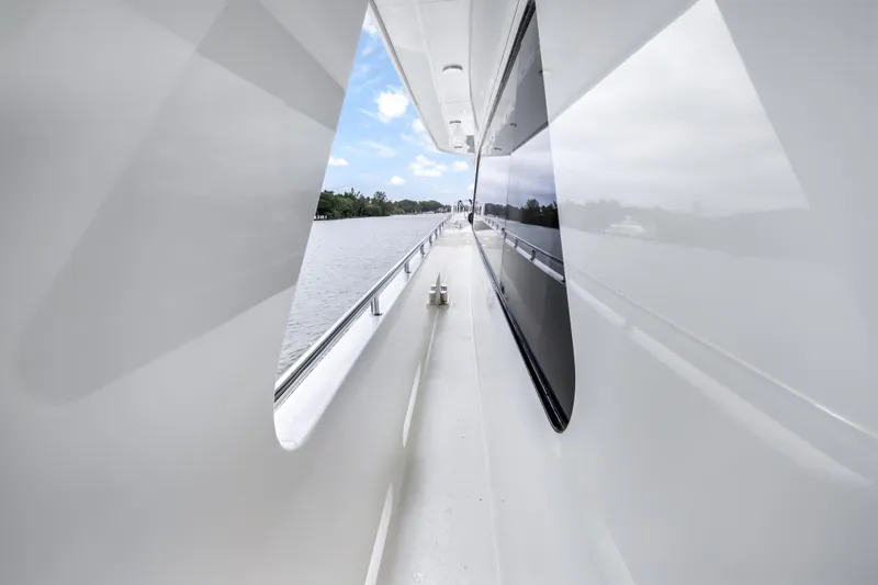 Jus Chill'n Yacht Photos Pics Side deck view of 2012 Cheoy Lee 84 Bravo yacht, showcasing sleek design and waterway.